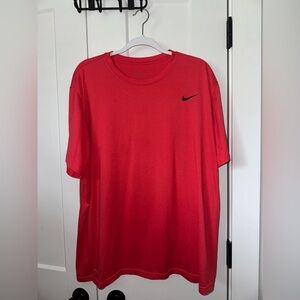 Red Nike shirt has stain